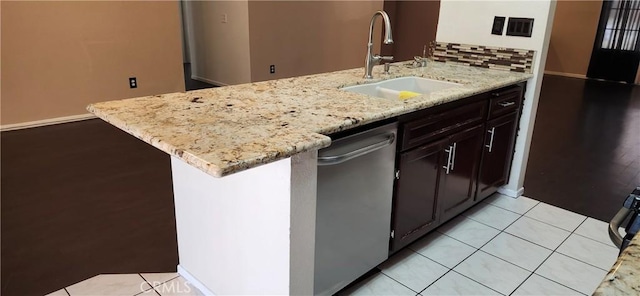 kitchen with light stone counters, sink, kitchen peninsula, and dishwasher