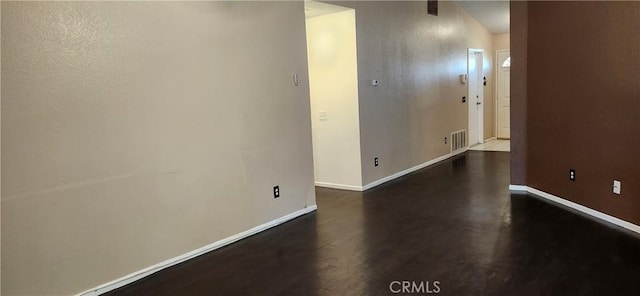 spare room with dark hardwood / wood-style flooring