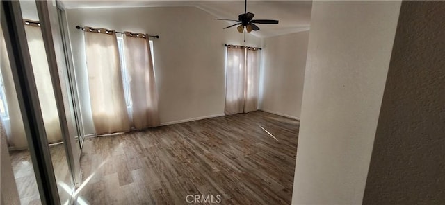 unfurnished room with ceiling fan, lofted ceiling, and wood-type flooring