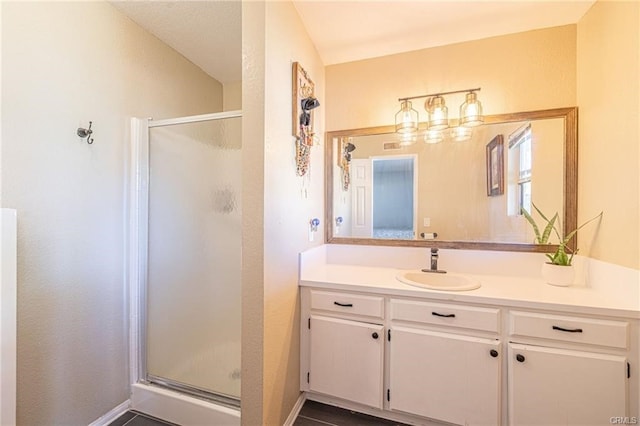 bathroom featuring vanity and a shower with shower door