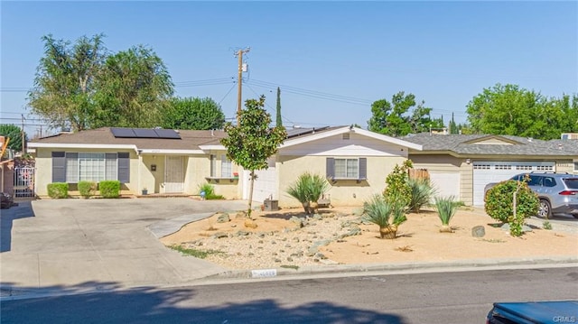 single story home featuring a garage and solar panels