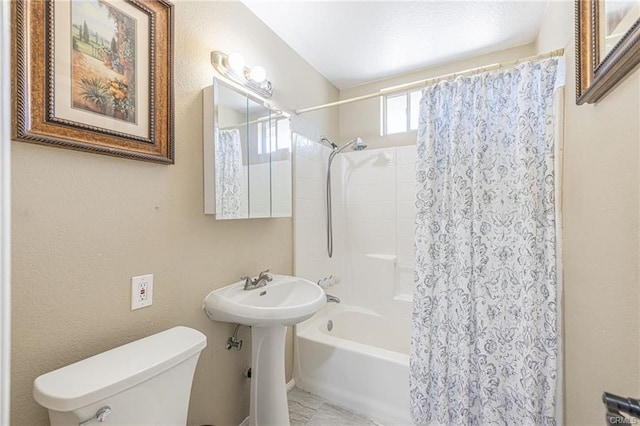 bathroom featuring shower / bath combination with curtain and toilet