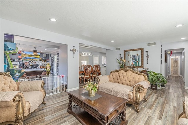 living room with hardwood / wood-style flooring and a textured ceiling