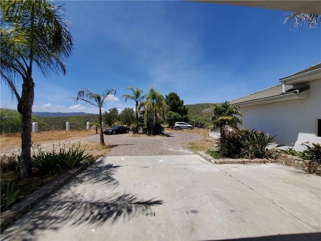 view of yard with a mountain view and a patio area