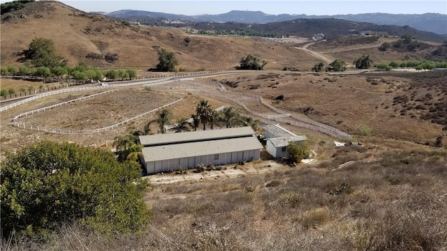 drone / aerial view featuring a mountain view and a rural view