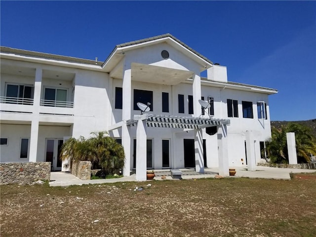 rear view of house featuring a pergola