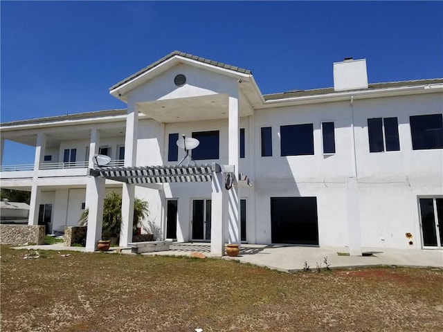 rear view of property featuring a patio and a pergola