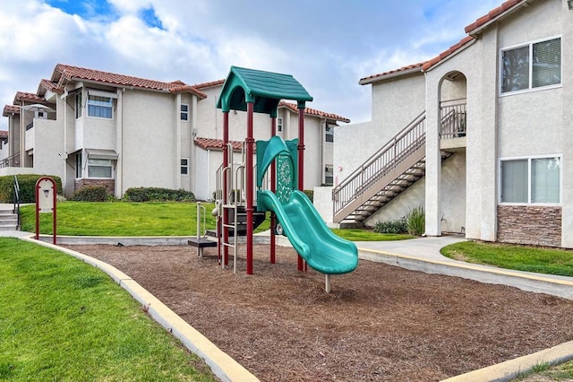 view of playground with a lawn