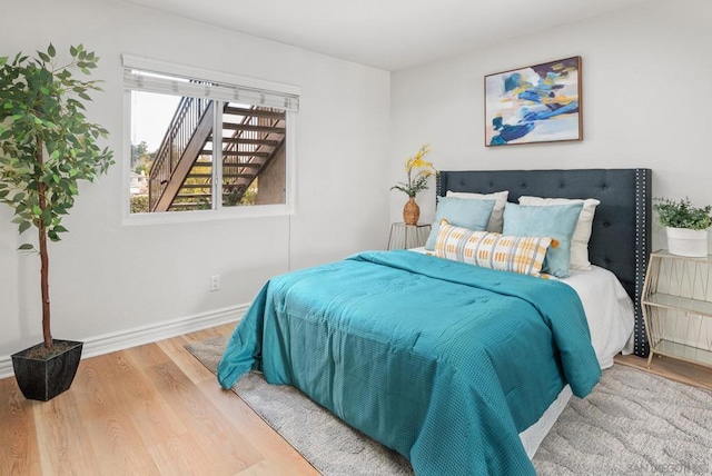 bedroom with hardwood / wood-style flooring