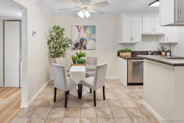 dining area with sink, light tile patterned floors, and ceiling fan