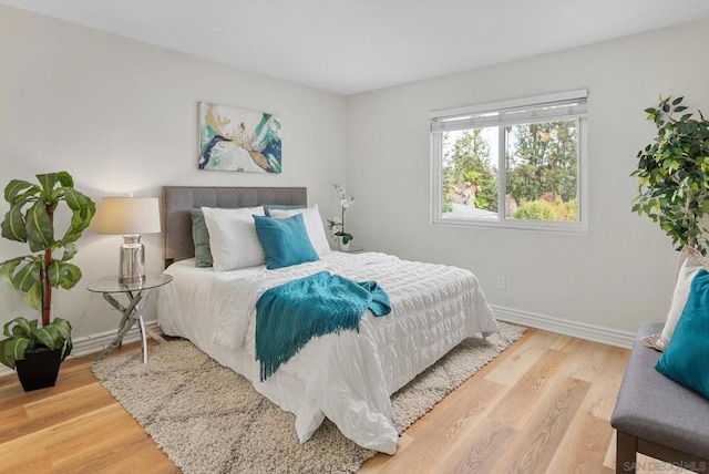 bedroom with hardwood / wood-style flooring