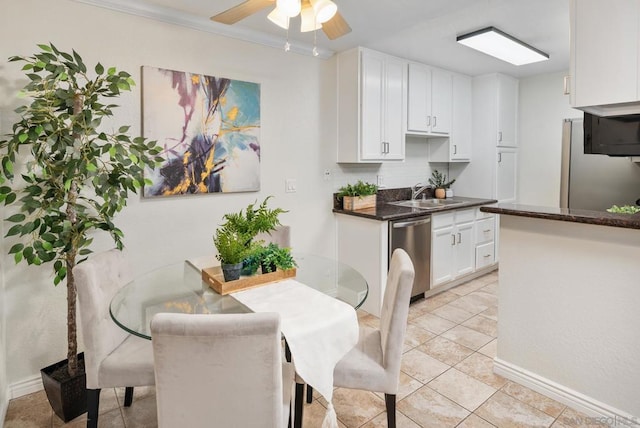 tiled dining room with sink and ceiling fan