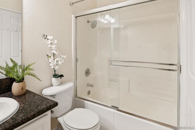 full bathroom featuring vanity, enclosed tub / shower combo, and toilet