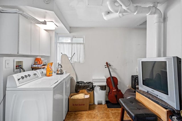 laundry room featuring cabinets, light tile patterned floors, and independent washer and dryer