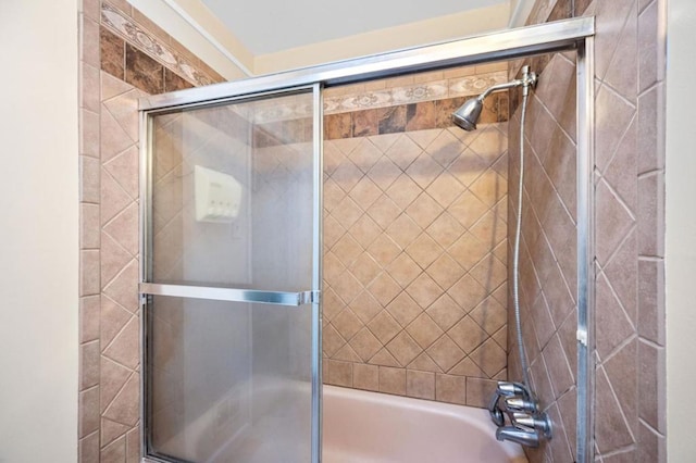 bathroom featuring combined bath / shower with glass door