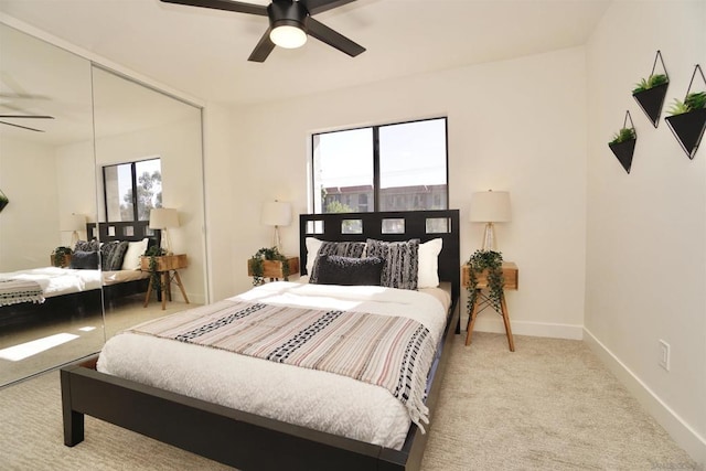 carpeted bedroom with multiple windows and ceiling fan