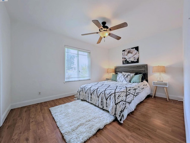 bedroom with ceiling fan and wood-type flooring