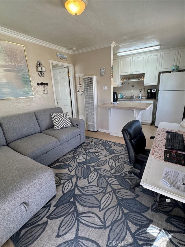 tiled home office featuring ornamental molding and a textured ceiling