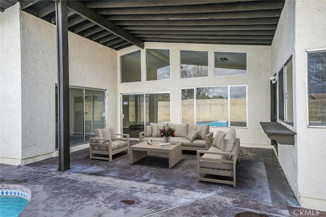 view of patio / terrace with an outdoor living space and a fenced in pool