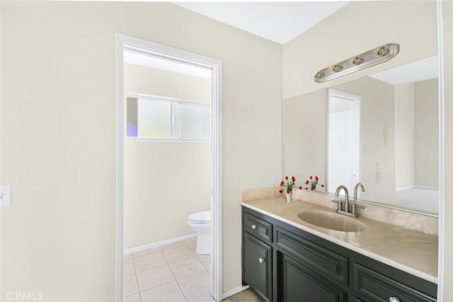 bathroom with vanity, tile patterned floors, and toilet