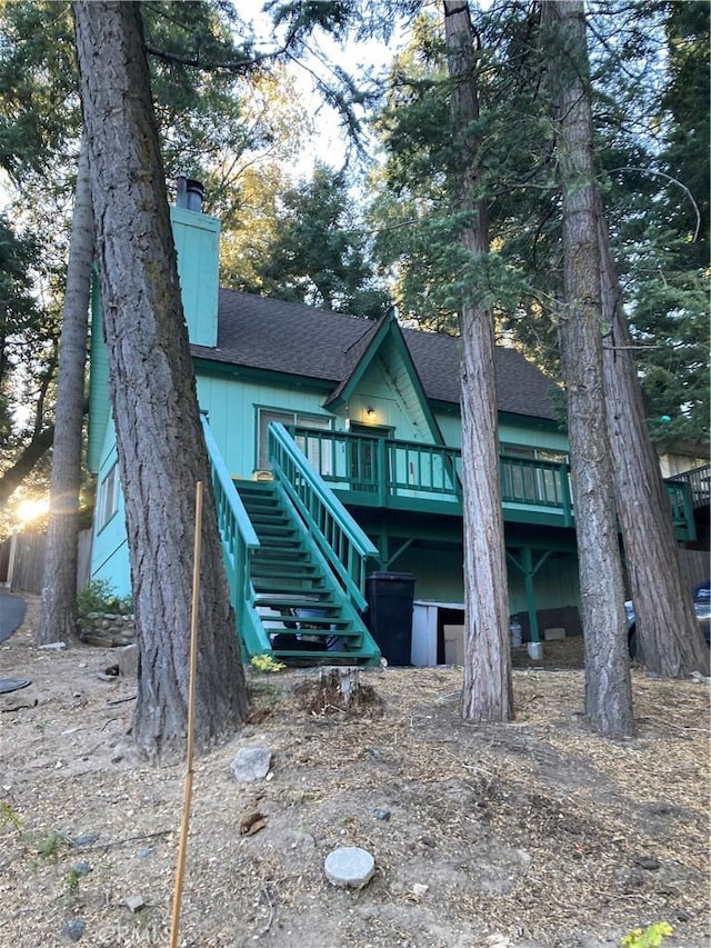 rear view of house featuring a deck