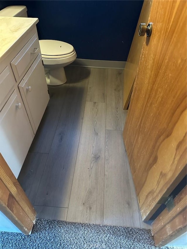 bathroom featuring vanity, hardwood / wood-style floors, and toilet