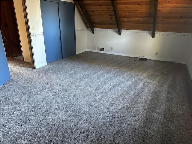 additional living space featuring wood ceiling, lofted ceiling with beams, and carpet