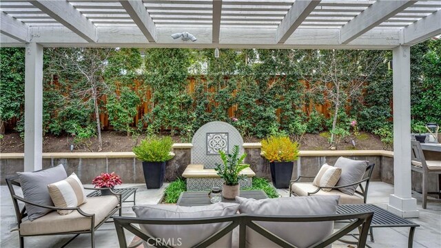 view of patio with an outdoor living space and a pergola