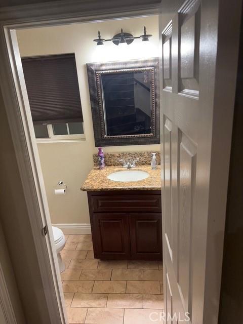 bathroom with vanity, toilet, and tile patterned flooring