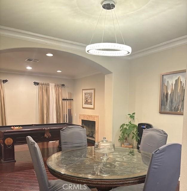 dining room with crown molding and hardwood / wood-style floors