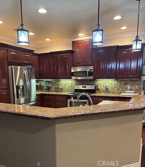 kitchen with stainless steel appliances, ornamental molding, pendant lighting, and stone counters