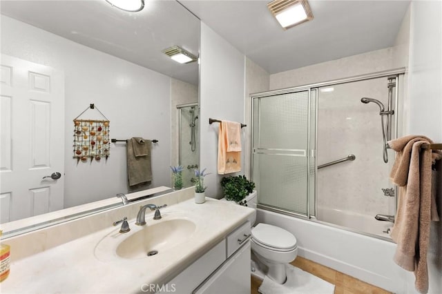 full bathroom featuring vanity, toilet, and combined bath / shower with glass door