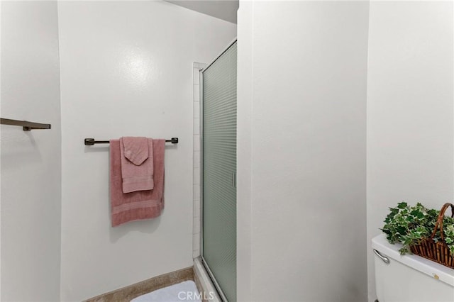 bathroom with walk in shower and toilet