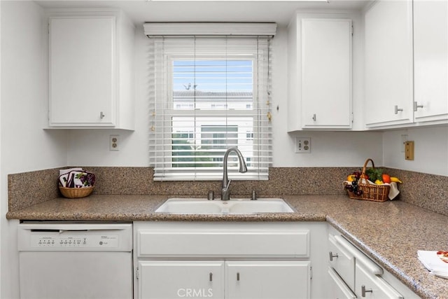 kitchen with white dishwasher, sink, and white cabinetry