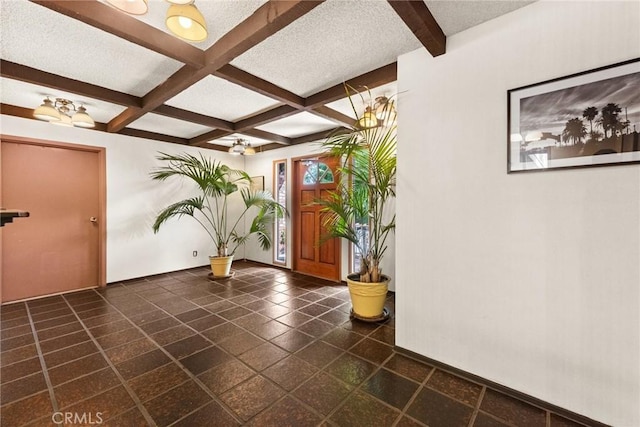 entrance foyer featuring coffered ceiling, a textured ceiling, and beam ceiling