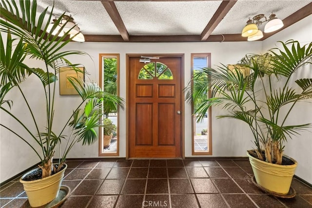 entrance foyer with beam ceiling and a textured ceiling