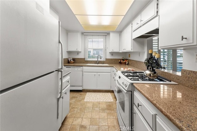 kitchen with white cabinetry, white appliances, sink, and light stone counters