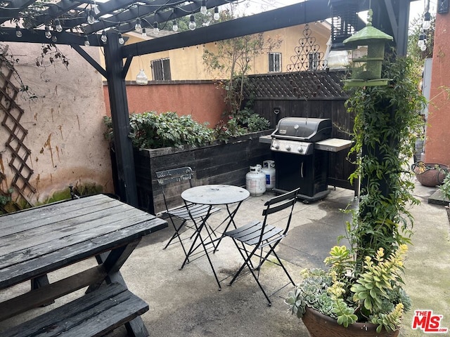 view of patio with a pergola and grilling area