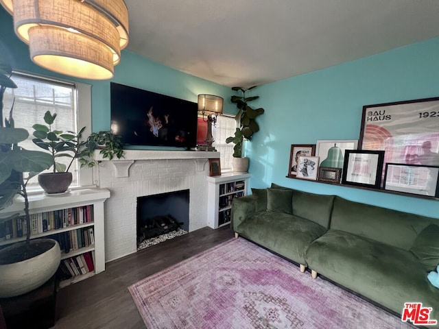 living room featuring hardwood / wood-style flooring and a fireplace