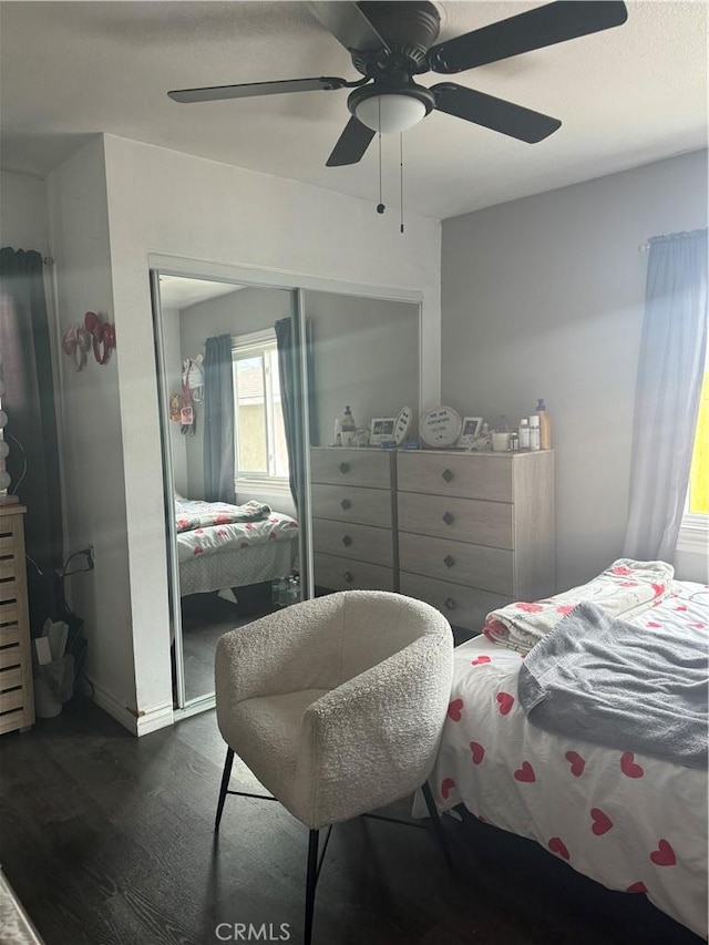 bedroom with ceiling fan, dark hardwood / wood-style floors, and a closet