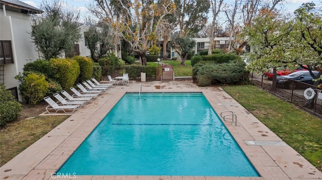 view of pool with a lawn and a patio area