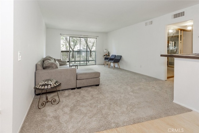 23515 Lyons Ave Unit 210, Valencia, CA 91355 - carpeted living area featuring baseboards and wood finished floors