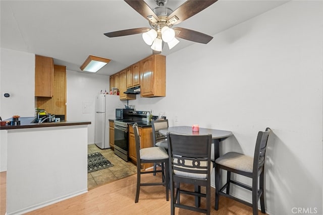 23515 Lyons Ave Unit 210, Valencia, CA 91355 - dining area with light wood-style floors and ceiling fan