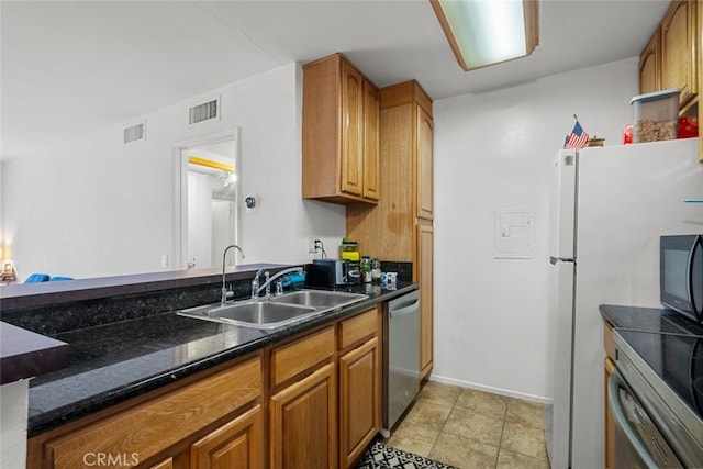 23515 Lyons Ave Unit 210, Valencia, CA 91355 - kitchen featuring dishwasher, brown cabinetry, freestanding refrigerator, and oven