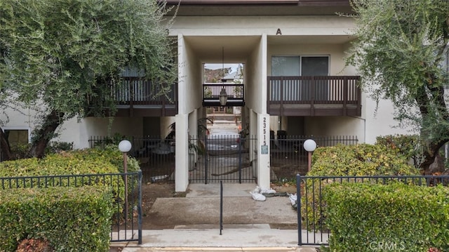 23515 Lyons Ave Unit 210, Valencia, CA 91355 - view of building exterior featuring a fenced front yard