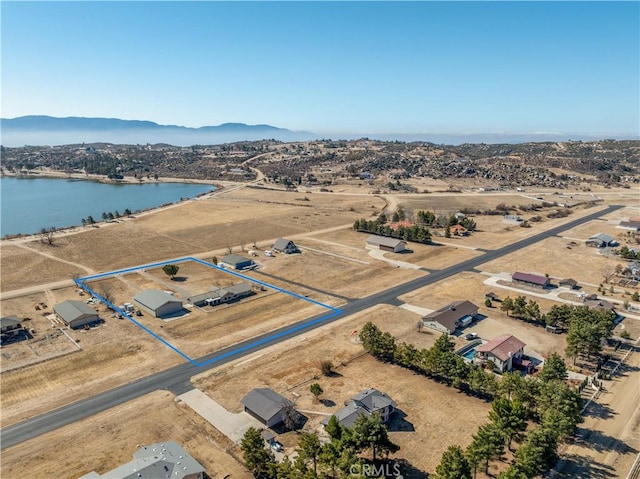 bird's eye view with a water and mountain view