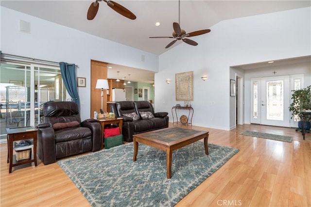 living room with hardwood / wood-style flooring and high vaulted ceiling