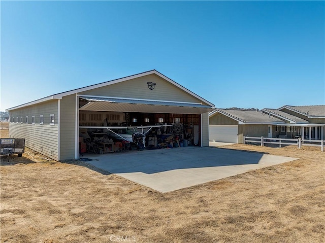 single story home with a garage and an outbuilding