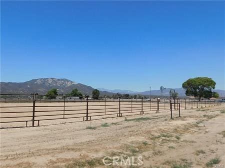 view of yard with a mountain view and a rural view