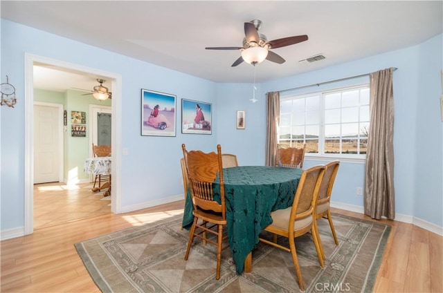 dining space featuring ceiling fan and light hardwood / wood-style floors